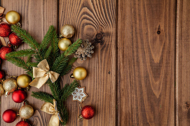 Christmas background with New year toys and fir tree branch on wooden table - Photo, Image