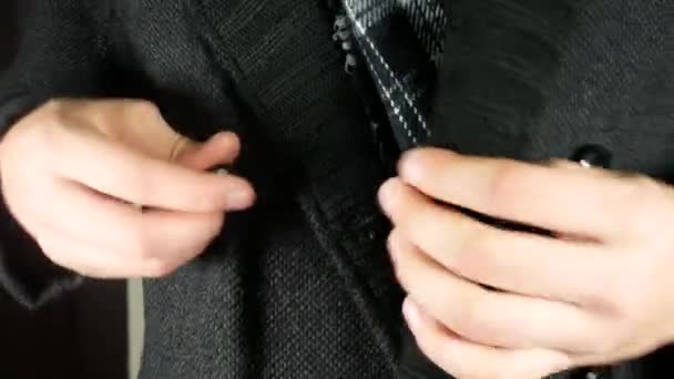 Κάποιος κουμπώνει το γκρι χειμωνιάτικο παλτό του - Πλάνα, βίντεο