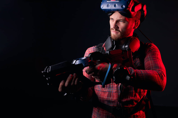 Side view on man holding VR weapon - Φωτογραφία, εικόνα