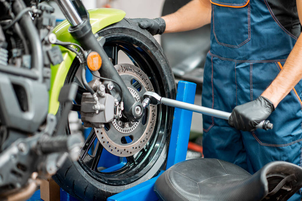 Repairing motorcycle at the workshop - Photo, Image