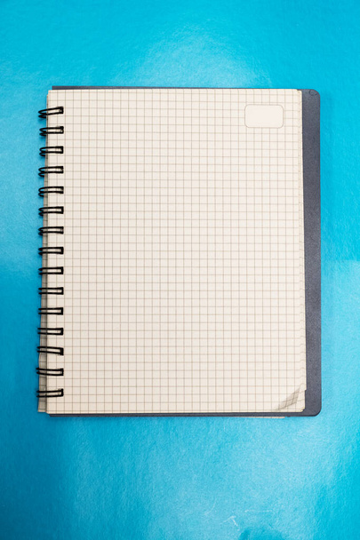 Blank sheet of notebook on blue background - Fotó, kép