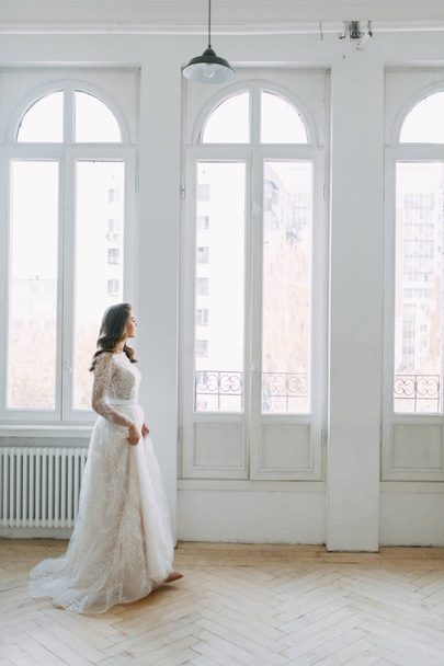 Beautiful girl in white dress, European wedding. Air and light photo shoot of the bride.  - Фото, зображення