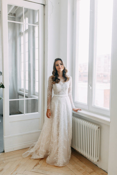 Beautiful girl in white dress, European wedding. Air and light photo shoot of the bride.  - Foto, Imagem