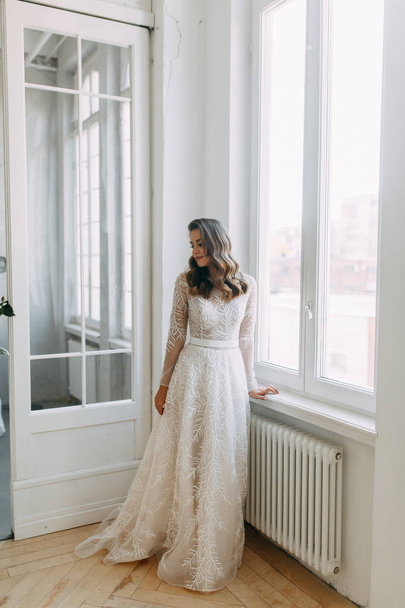 Beautiful girl in white dress, European wedding. Air and light photo shoot of the bride.  - Foto, Bild