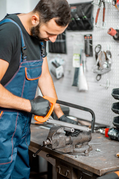 Handyman working with metal at the workshop - Фото, изображение