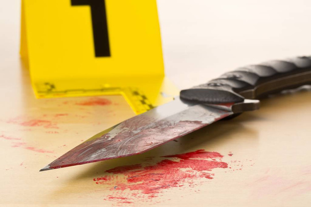 Crime scene investigation CSI evidence marker with bloody knife  - Foto, Imagem