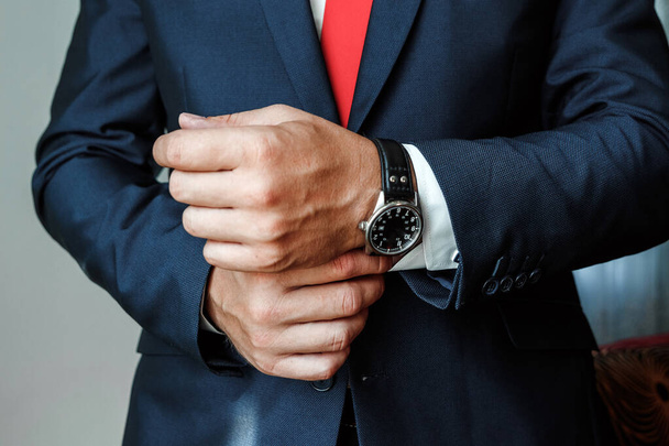 Hands of a businessman, close-up, buttons on a watch - Foto, imagen