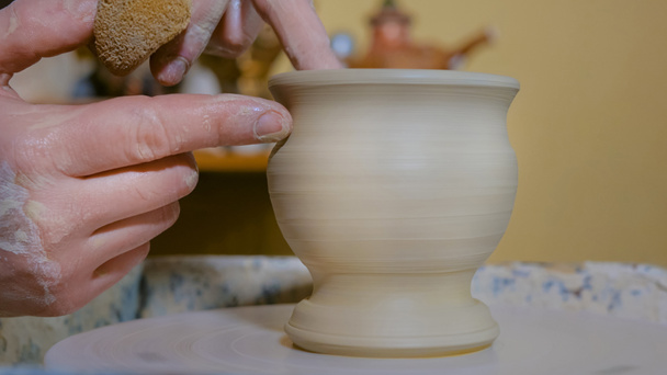 Professional potter shaping mug with special tool in pottery workshop - Photo, Image
