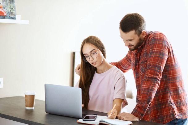 Young couple spends time near computer screen - Foto, Imagen