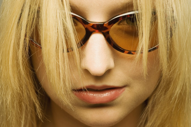 Young Woman With Hair Hanging In Front Of Sunglasses - Foto, immagini