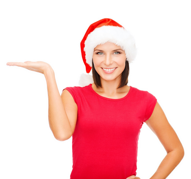Woman in santa helper hat with something on palm - 写真・画像