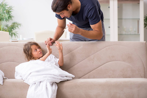 Father taking care of his ill daughter - Photo, image
