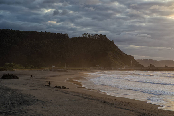 Sunset on Asturias beach. Clouds over the Cantabrian Sea - Photo, Image
