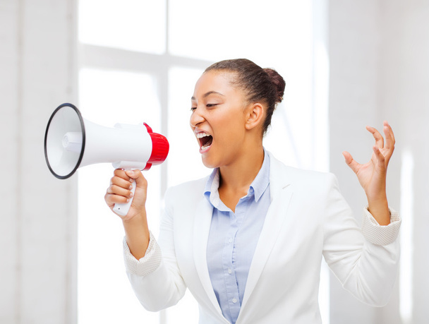 Strict businesswoman shouting in megaphone - Photo, Image