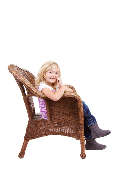 little girl sitting on a chair - Foto, afbeelding