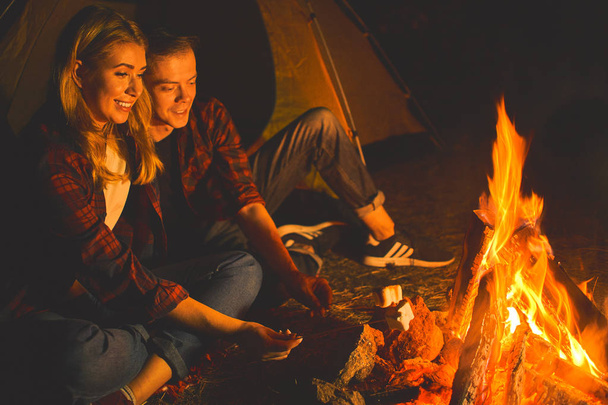 Couple enjoy vacation or weekend forest. Best friends spend leisure, weekend hike barbecue forest nature background. Romantic picnic forest. Picnic with friends in forest near bonfire. - Photo, Image