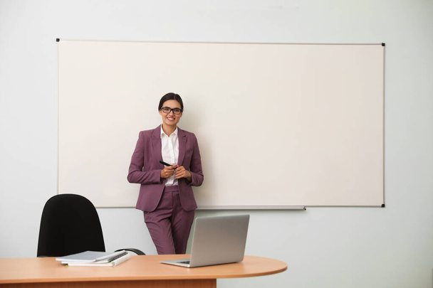 Female teacher near whiteboard in modern classroom - Zdjęcie, obraz