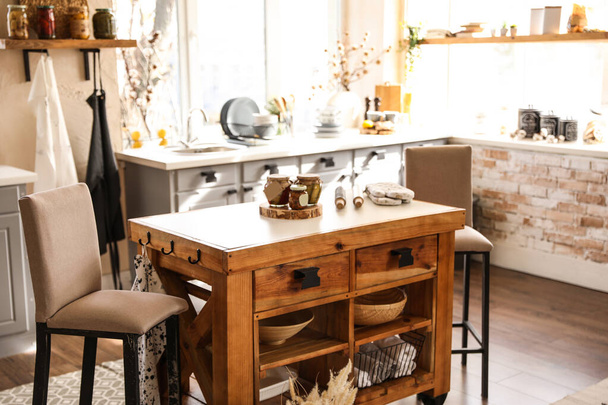 Stylish kitchen interior with wooden table and chairs - 写真・画像