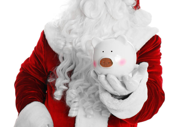 Santa Claus holding piggy bank on white background, closeup - Foto, afbeelding