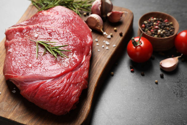 Fresh raw meat on grey table, closeup - Fotó, kép