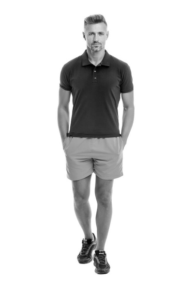 Sport style. Menswear and fashionable clothing. Man calm face posing confidently white background. Man looks handsome in shirt and shorts. Guy sport outfit. Fashion concept. Man model clothes shop - Foto, Imagen