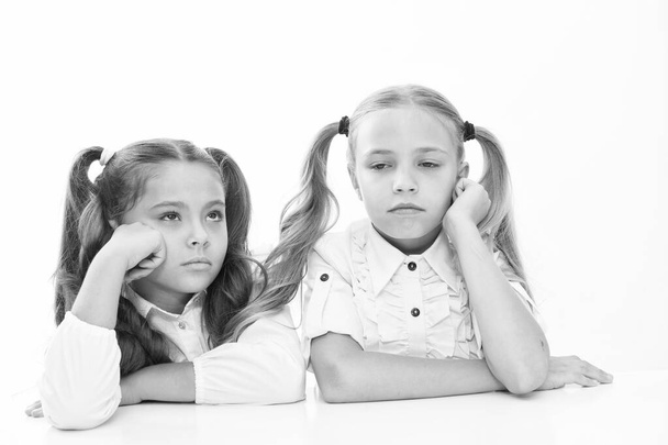 Feeling bored. Cute children having lesson isolated on white. Little children wearing school uniform. School children with fashion look. Small children with ponytails are back to school - Foto, Imagen