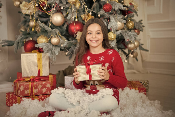 Happy new year. Christmas. Kid enjoy the holiday. small happy girl at christmas. The morning before Xmas. New year holiday. little child girl likes xmas present. Opening Christmas present - Фото, зображення