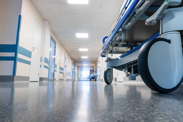 Medical bed on wheels in the hospital corridor.  - Fotó, kép