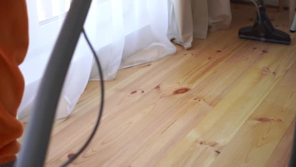 cleaning a wooden floor with a washing vacuum cleaner, slow motion - Footage, Video
