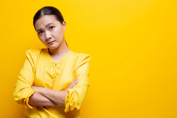 Sad woman isolated over yellow background - Φωτογραφία, εικόνα