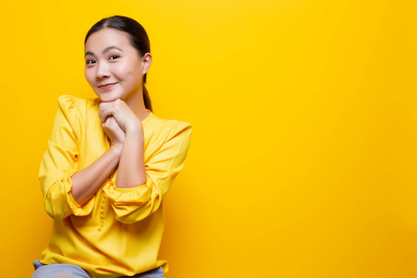 Woman feel shy standing isolated over yellow background - Photo, image