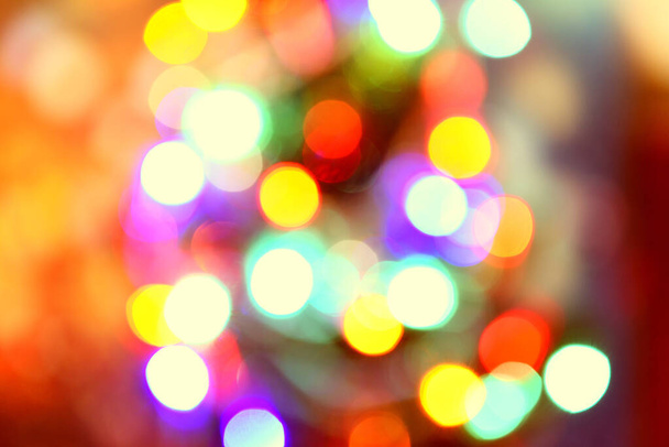 Blurred colorful bokeh and lights decorated christmas tree on bl - Photo, Image