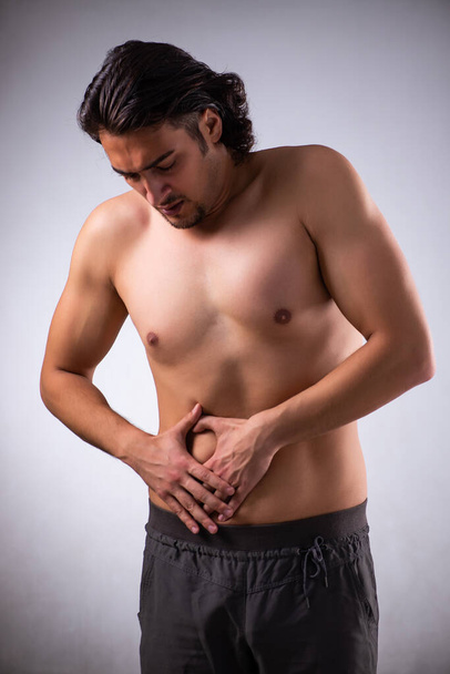 Young man suffering from stomachache - Φωτογραφία, εικόνα