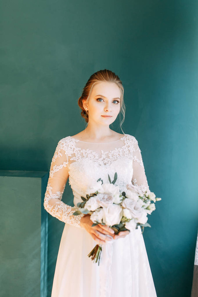 European-style wedding at the hotel. Bride in a white dress in the interior Studio.  - Zdjęcie, obraz