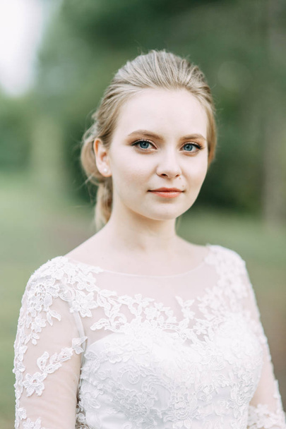 Elegant ceremony in European style. Beautiful bride in white flying dress in the forest.  - Valokuva, kuva