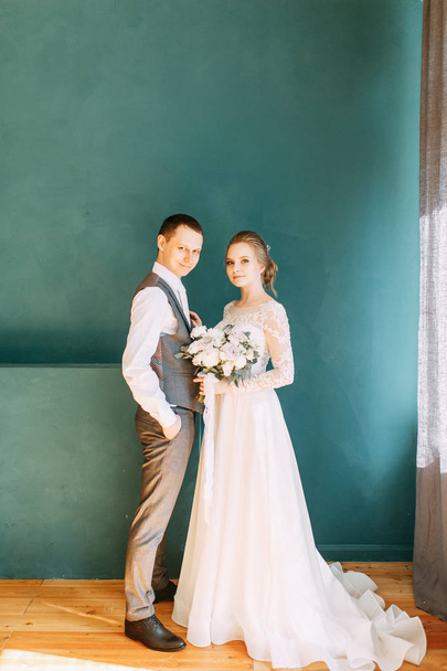 Modern ceremony in European style. Beautiful wedding couple in a bright Studio.  - Photo, image