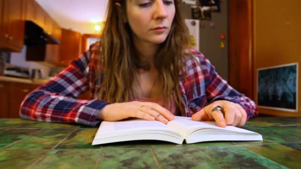 Woman is reading a book at the table - Footage, Video