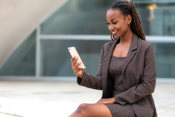 Portrait professionnel de femme d'affaires utilisant un téléphone portable en dehors du lieu de travail
 - Photo, image