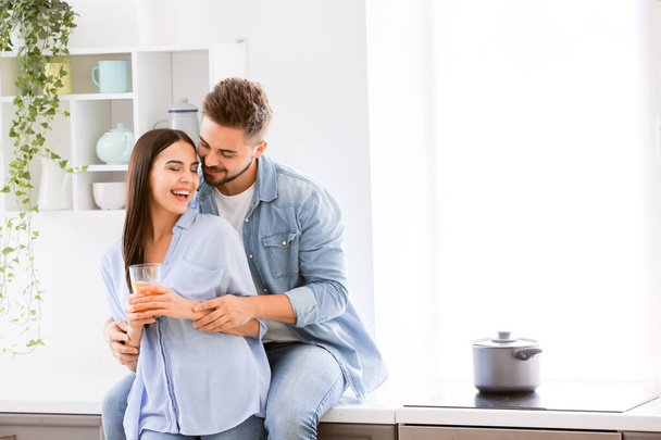 Happy young couple in kitchen at home - Foto, Bild