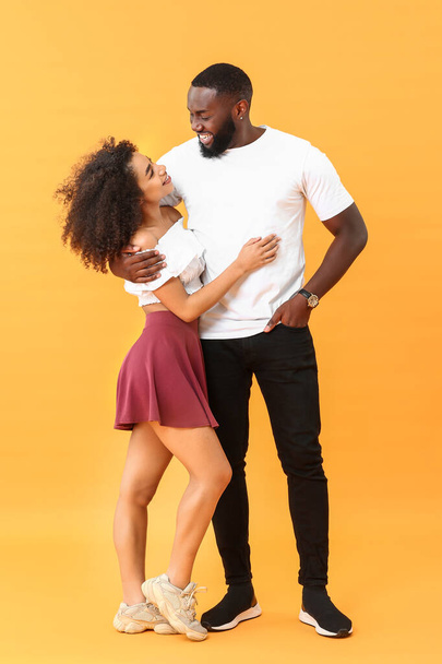 Portrait of happy African-American couple on color background - Foto, Imagen