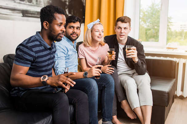 Group of friends watching television at home together - Photo, image