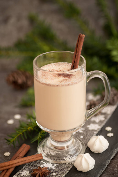 Eggnog in glass cups with a delicate foam, spices and a cinnamon stick - Fotografie, Obrázek