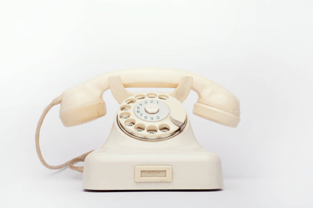Old telephone on the white background - Valokuva, kuva