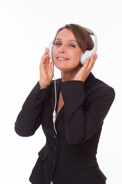 Businesswoman with earphones on white - Foto, Imagem