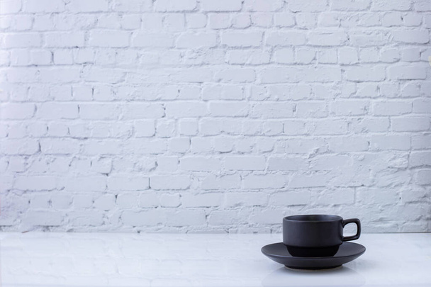 cup of tea on white brick wall texture background. - Фото, изображение