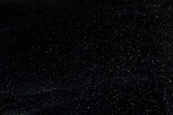 abstrato poeira real flutuando sobre fundo preto para - Foto, Imagem