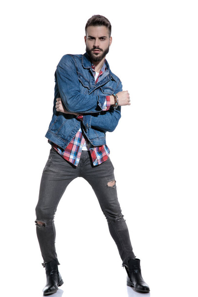 cool fashion guy posing and holding elbow in a fashion pose - Photo, image