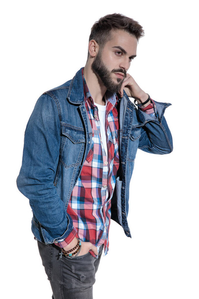 cool fashion guy in plaid shirt holding hand to face - Foto, Imagen