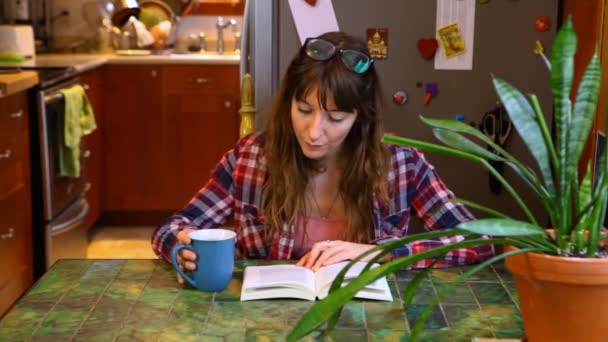 Mulher está lendo um livro na mesa
 - Filmagem, Vídeo