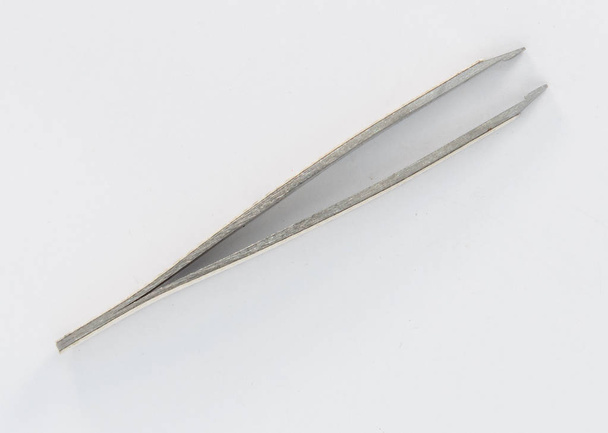 Metal tweezers to remove hairs from the face - Photo, Image